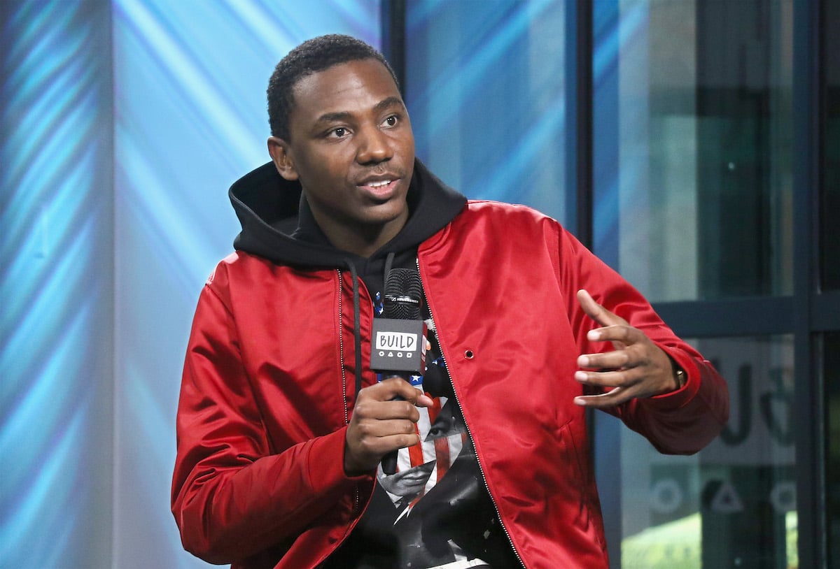 Jerrod Carmichael wearing a red jacket and speaking at Build