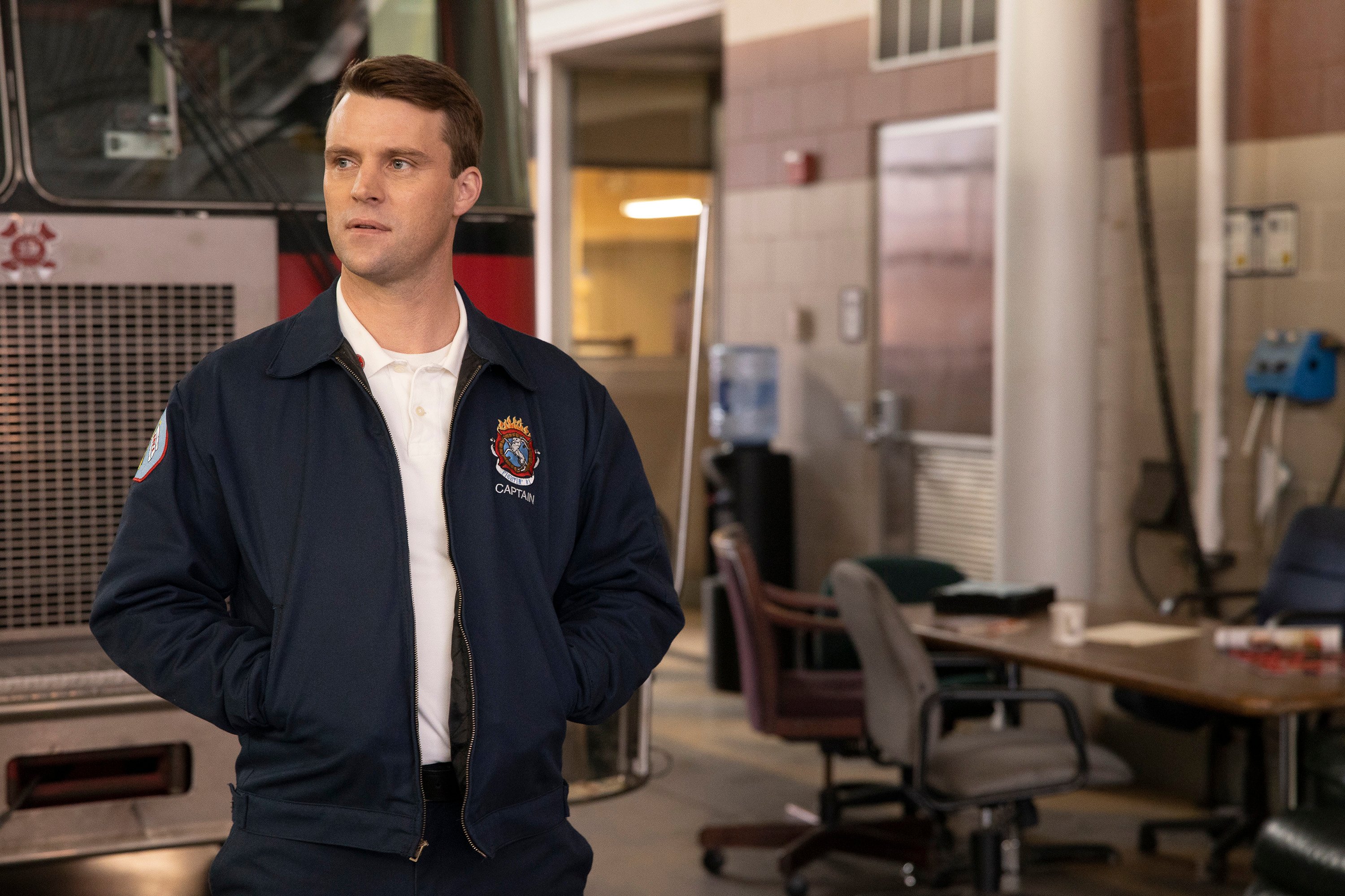 Jesse Spencer plays Matt Casey on Chicago Fire as he stands in the firehouse. 