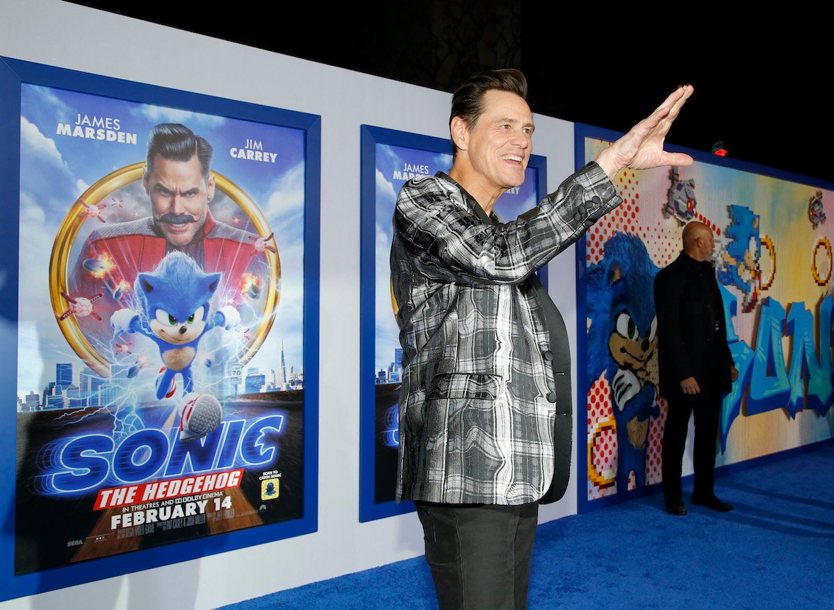 ‘Sonic the Hedgehog’ star Jim Carrey poses in front of the movie’s poster