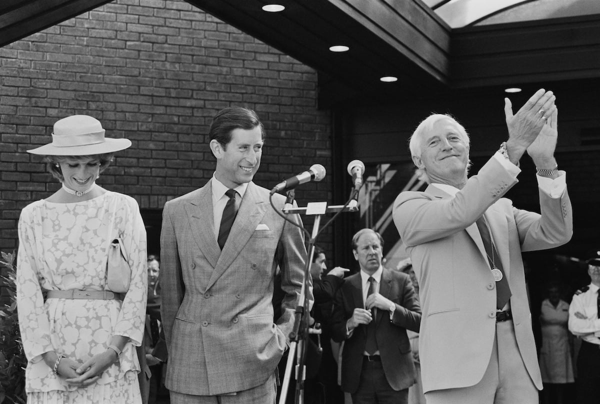Diana, Princess of Wales, Charles, Prince of Wales, and English DJ and broadcaster Jimmy Savile applaud at the opening of the National Spinal Injuries Centre in 1983