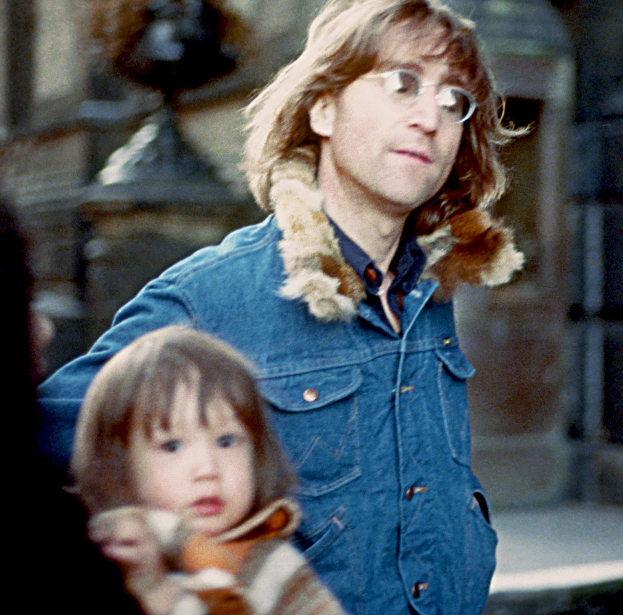 John Lennon wearing a jean jacket with his son, Sean Ono Lennon