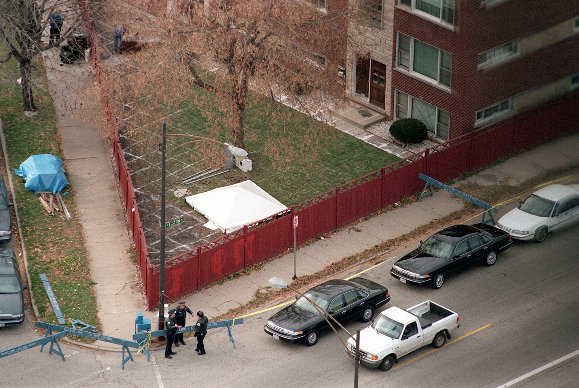 John Wayne Gacy excavation location overhead with a white tent over the dig site and cars in the street