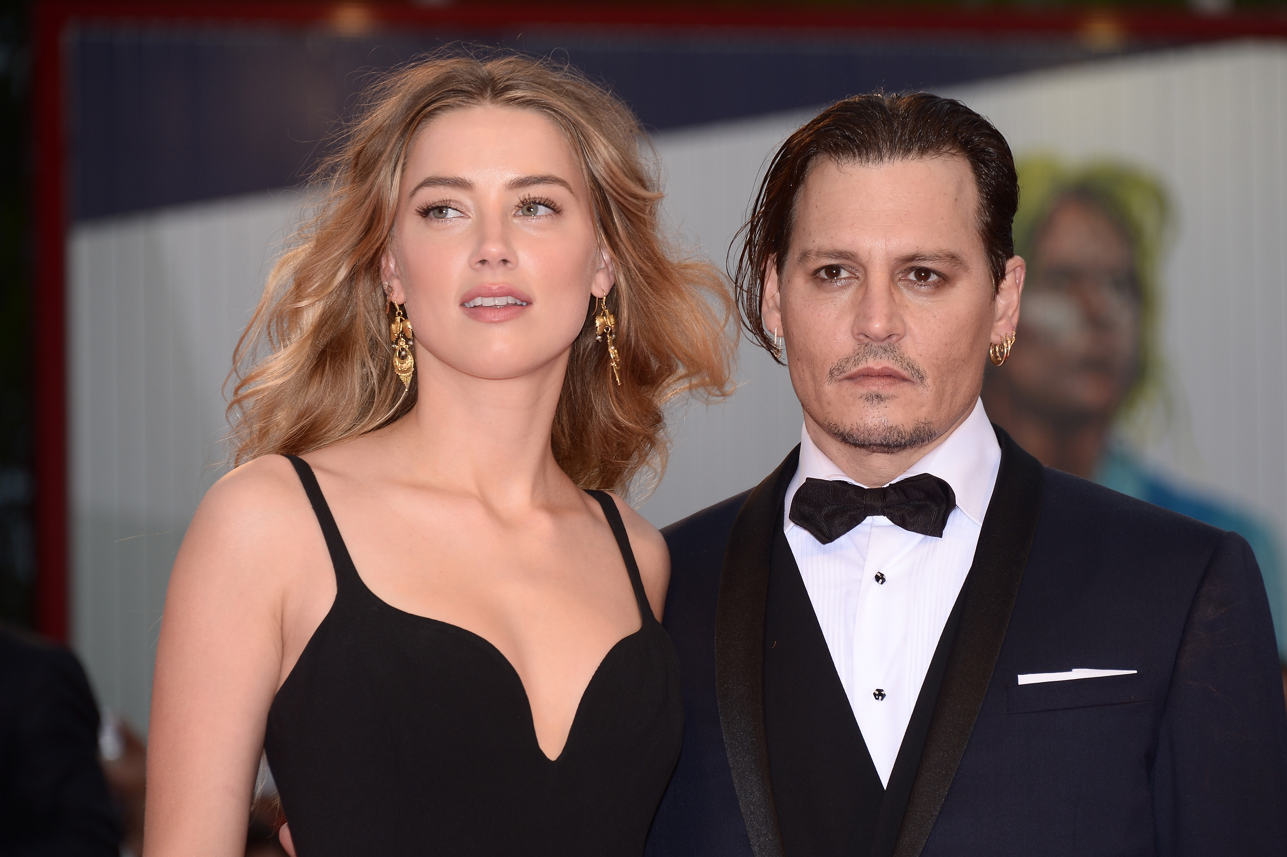 Johnny Depp, who once owned a yacht named after his ex-girlfriend, and and Amber Heard arrive on the red carpet at the Venice Film Festival in 2015