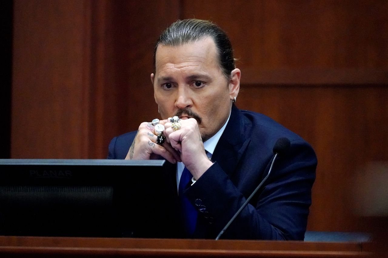 Johnny Depp, whose divorce from Amber Heard came up in court, testifies in the courtroom at the Fairfax County Circuit Courthouse.