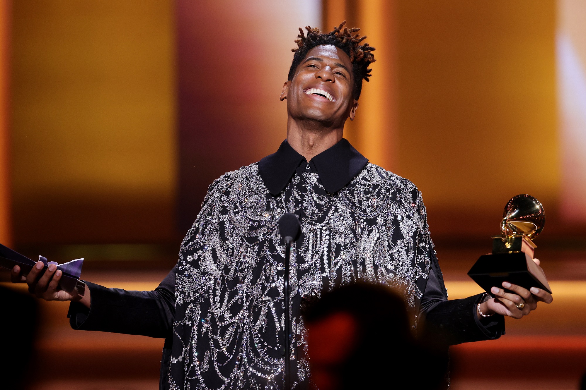 Jon Batiste on stage accepting the Album of the Year award at the 2022 Grammy Awards