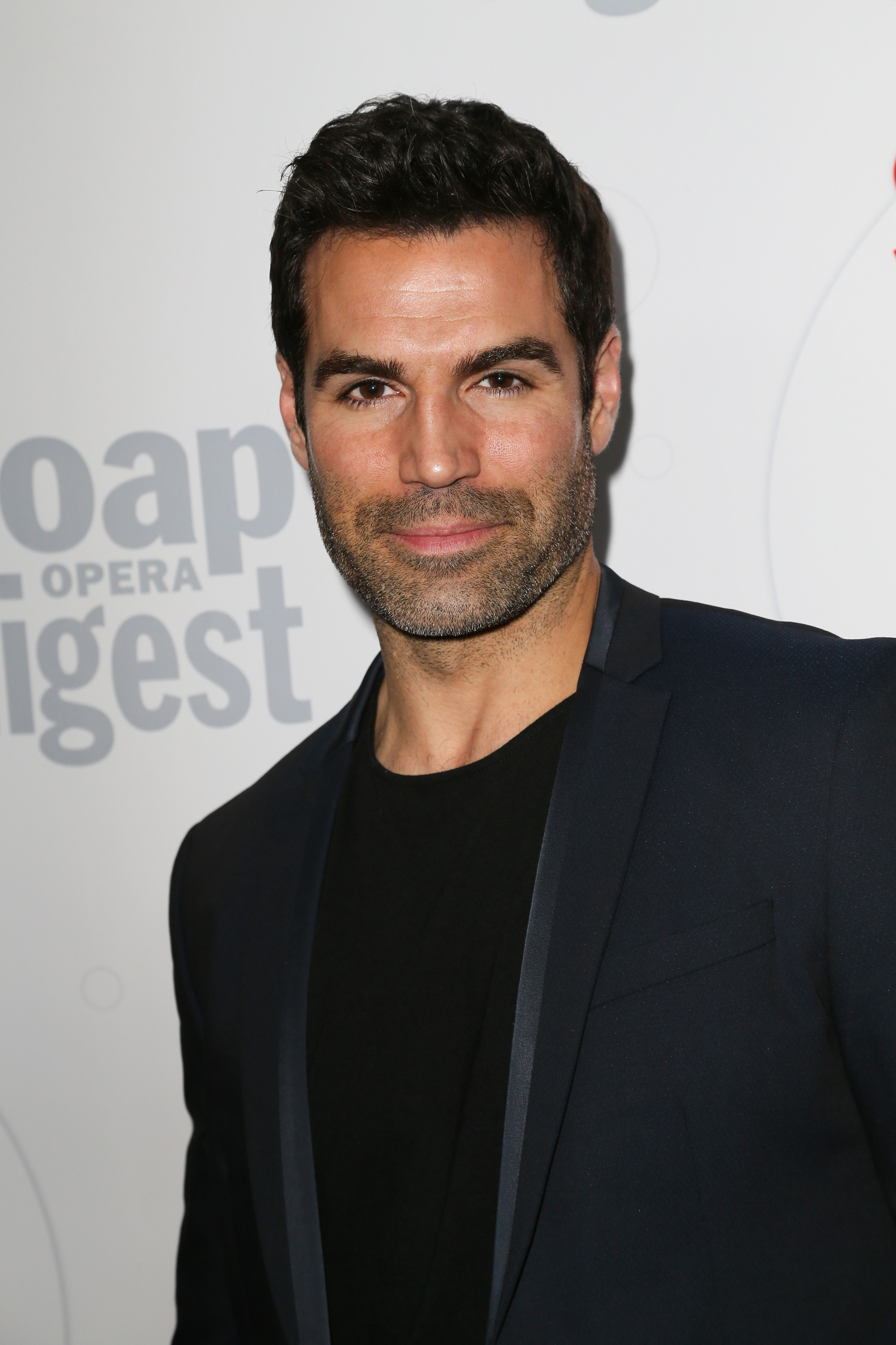 'The Young and the Restless' actor Jordi Vilasuso wearing a black shirt and suit during a red carpet appearance.