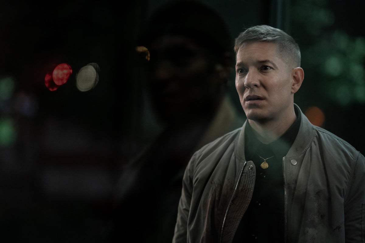 Joseph Sikora as Tommy Egan wearing a shocked expression and an olive jacket in 'Power Book IV: Force'