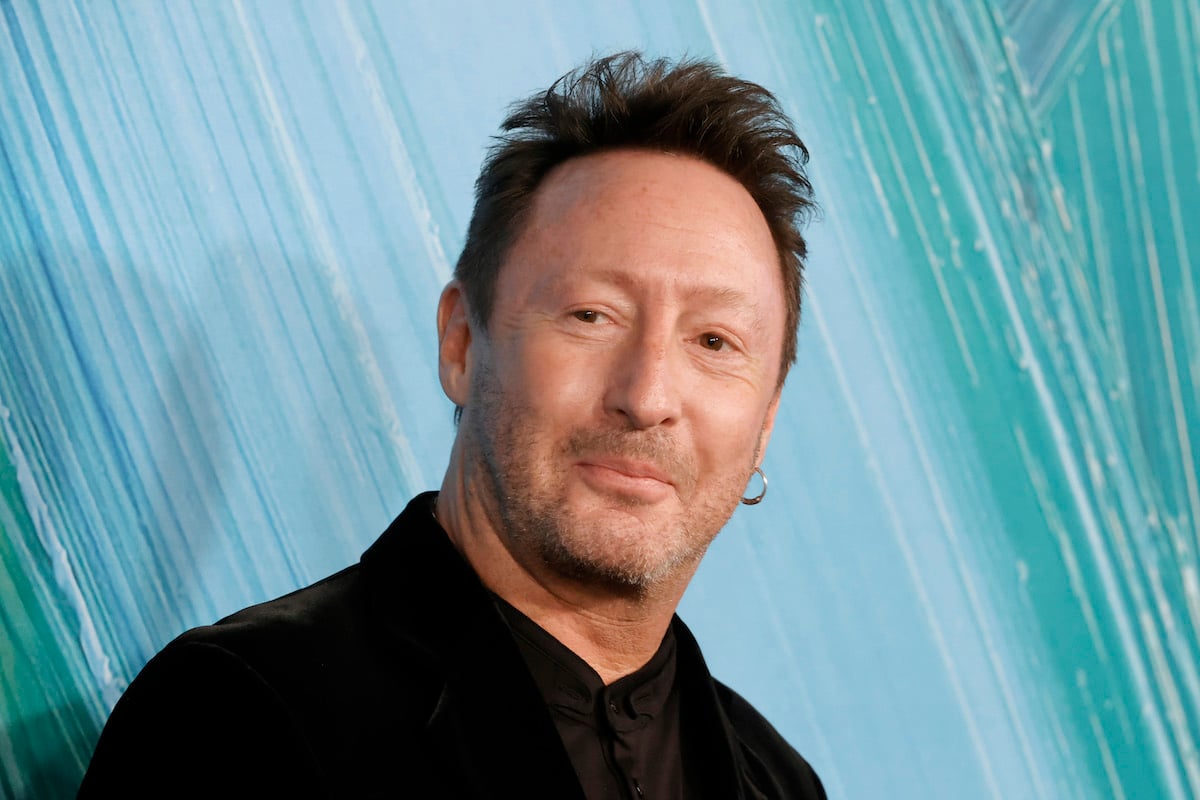 Julian Lennon smiles and poses at an event.