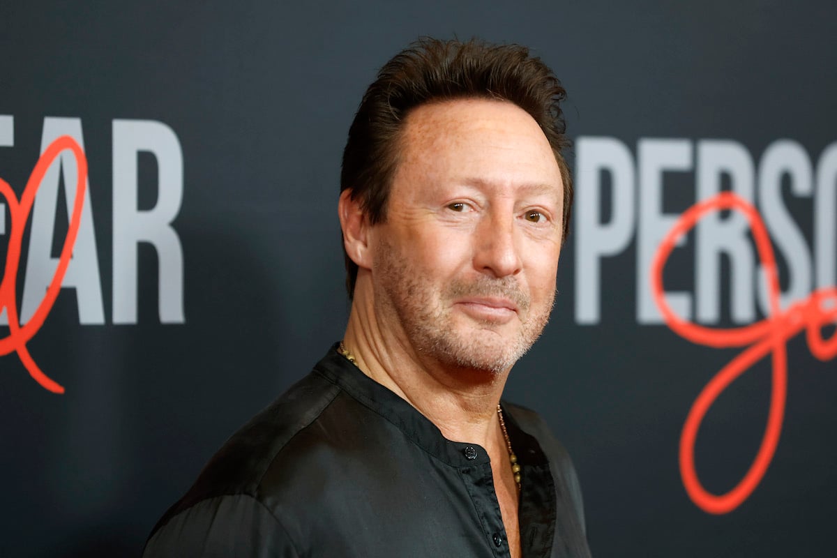 Julian Lennon smiles and poses at an event.