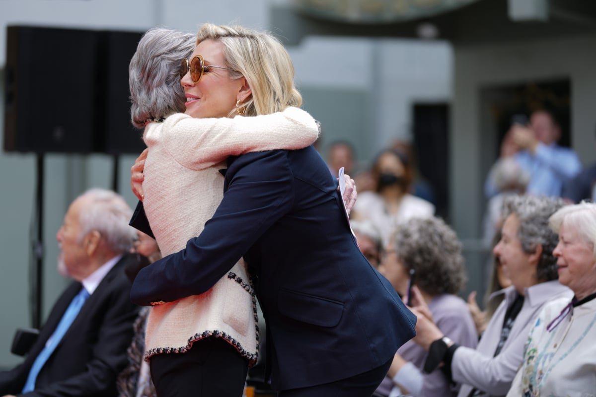 Grace and Frankie stars June Diane Raphael and Jane Fonda hug at the Hand and Footprint Ceremony.