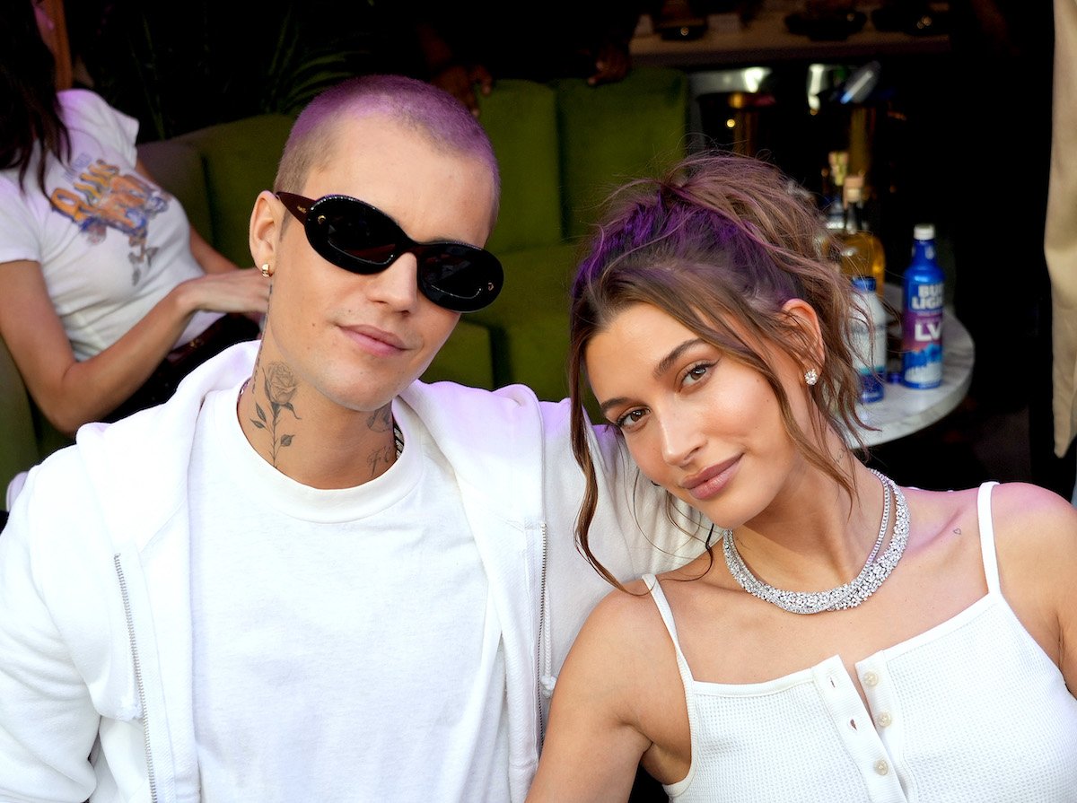 Justin Bieber and Hailey Bieber smile and pose together.