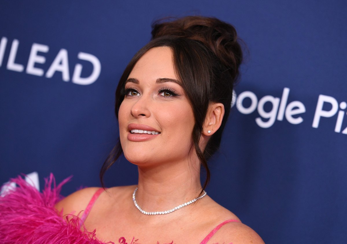 Kacey Musgraves smiles and poses at an event.