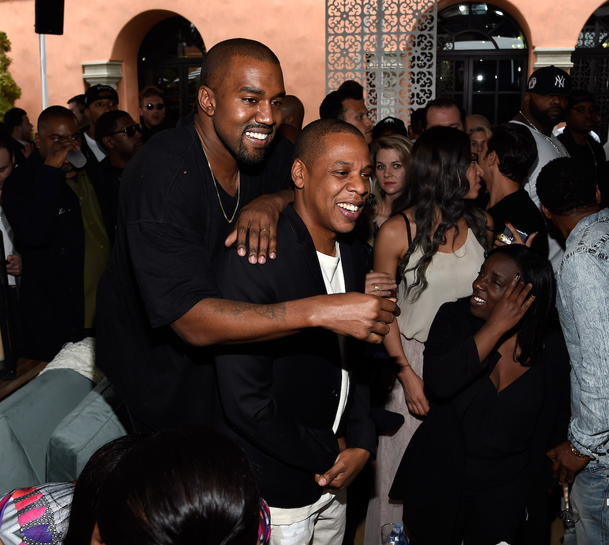 Rappers Kanye West and Jay-Z hug during the Roc Nation pre-GRAMMY Brunch in 2015