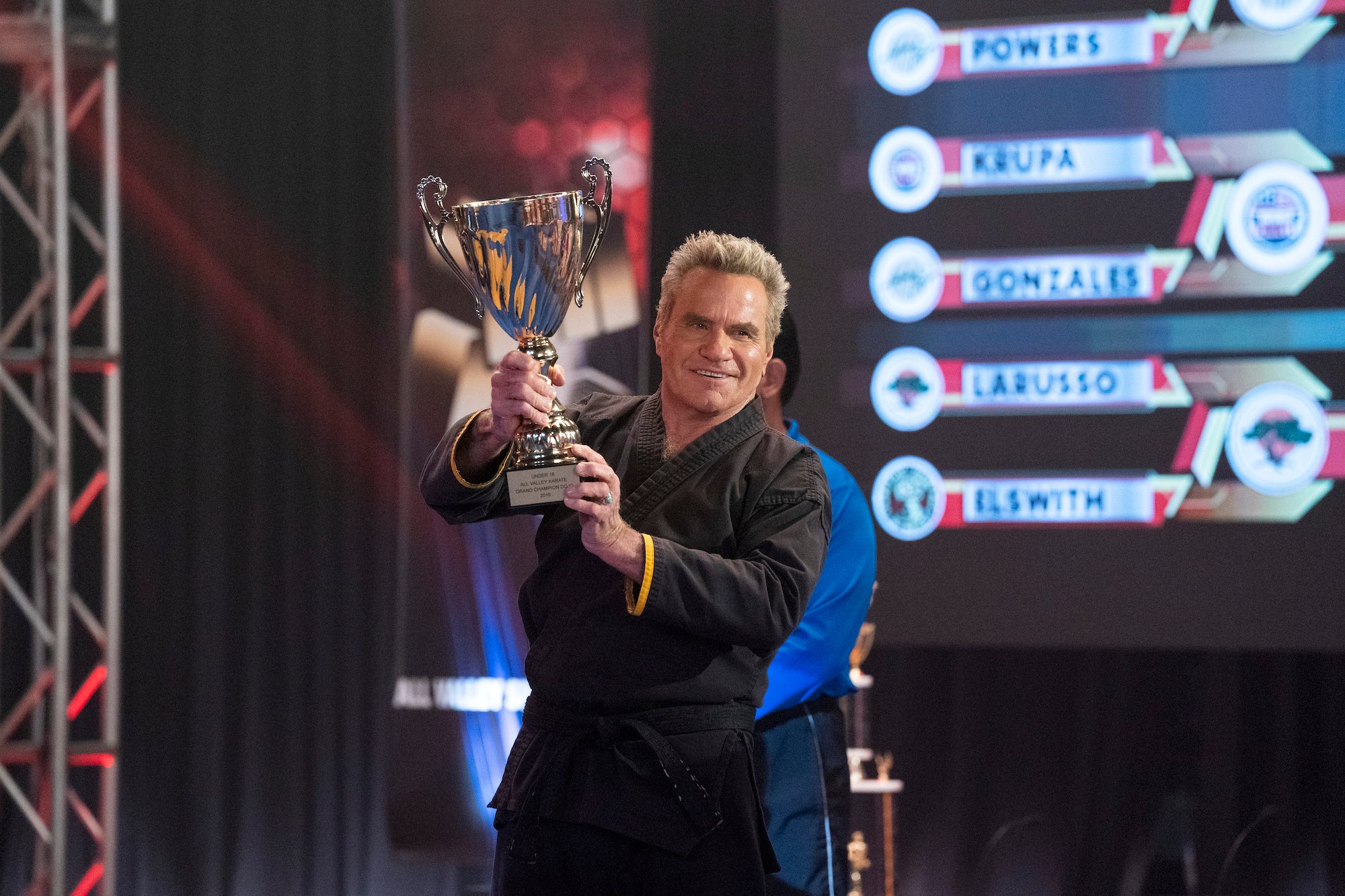 'Karate Kid' star Martin Kove holds a trophy for Cobra Kai