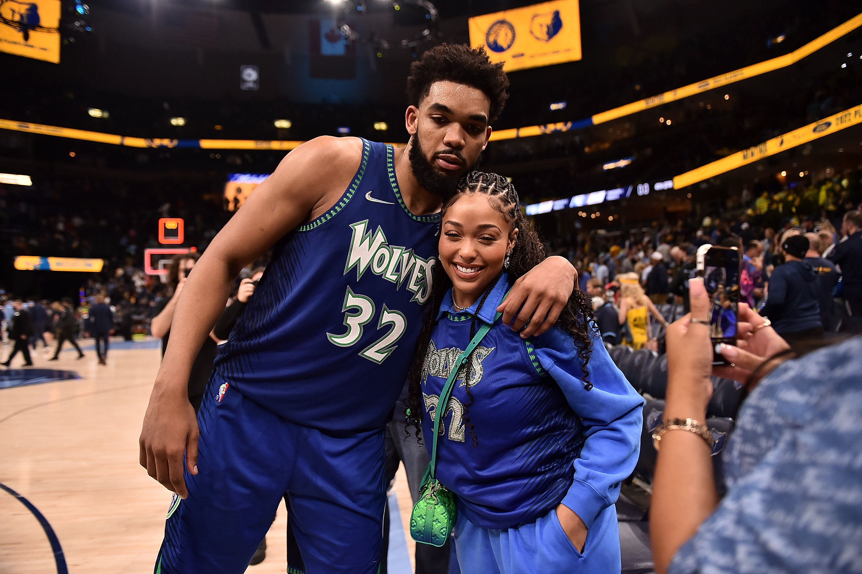 Karl-Anthony Towns and Jordyn Woods, who both have a sizable net worth, smile for photo at a playoff game against the Memphis Grizzlies