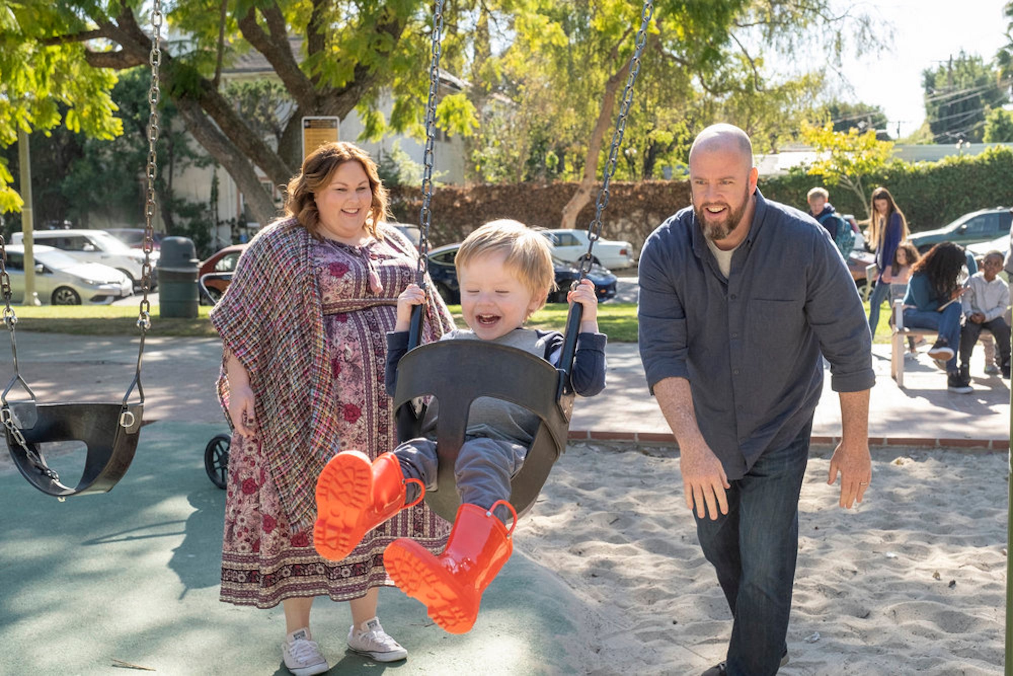 Kate and Toby pushing baby Jack on a swing in Chrissy Metz as Kate, Chris Sullivan as Toby in 'This Is Us' Season 6