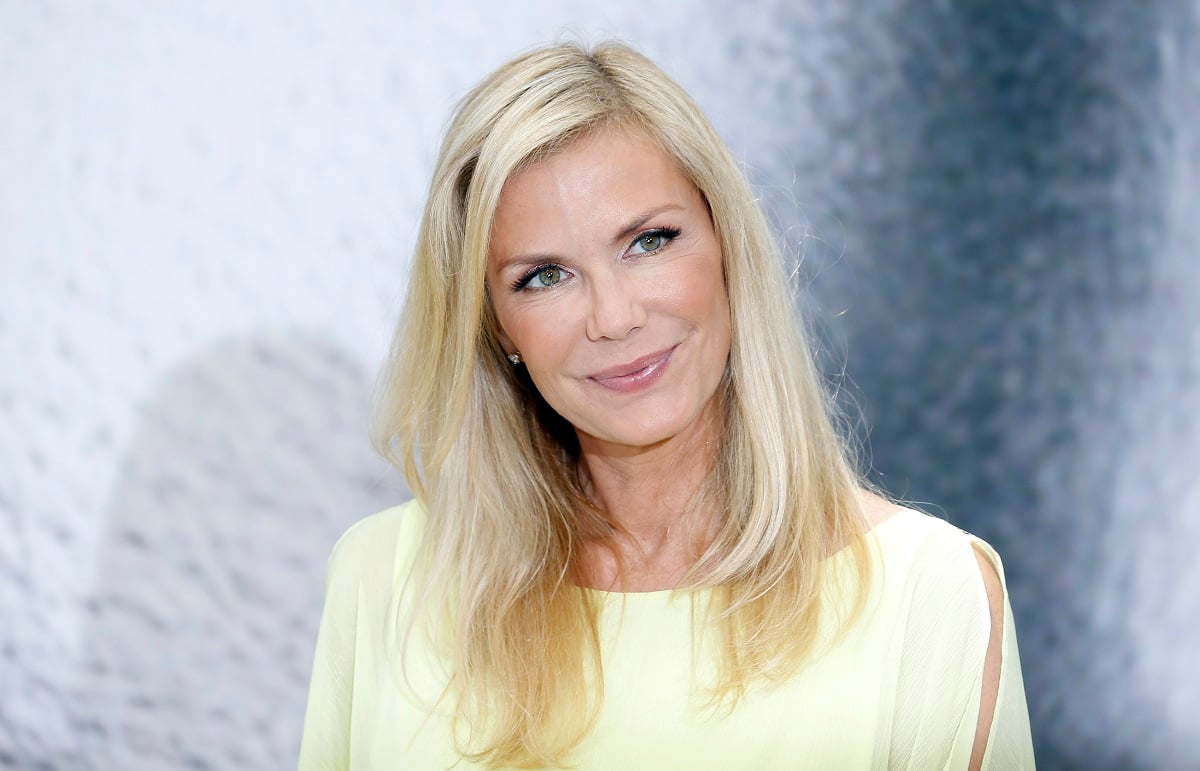 'The Bold and the Beautiful' actor Katherine Kelly Lang wearing a yellow blouse and standing in front of a black and white backdrop.