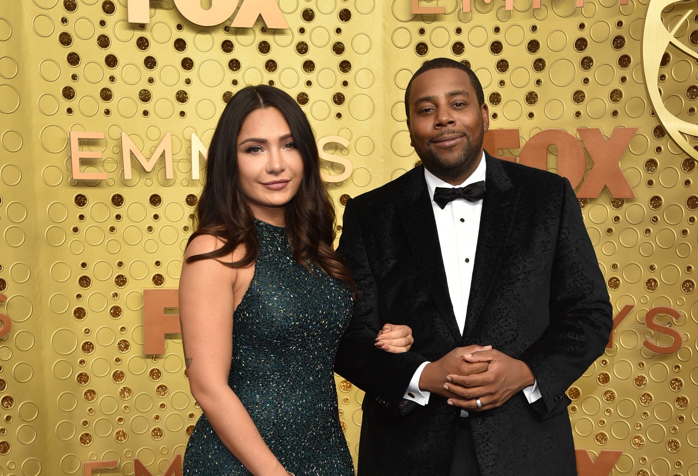 Christina Evangeline and Kenan Thompson pose together at the Emmy awards.