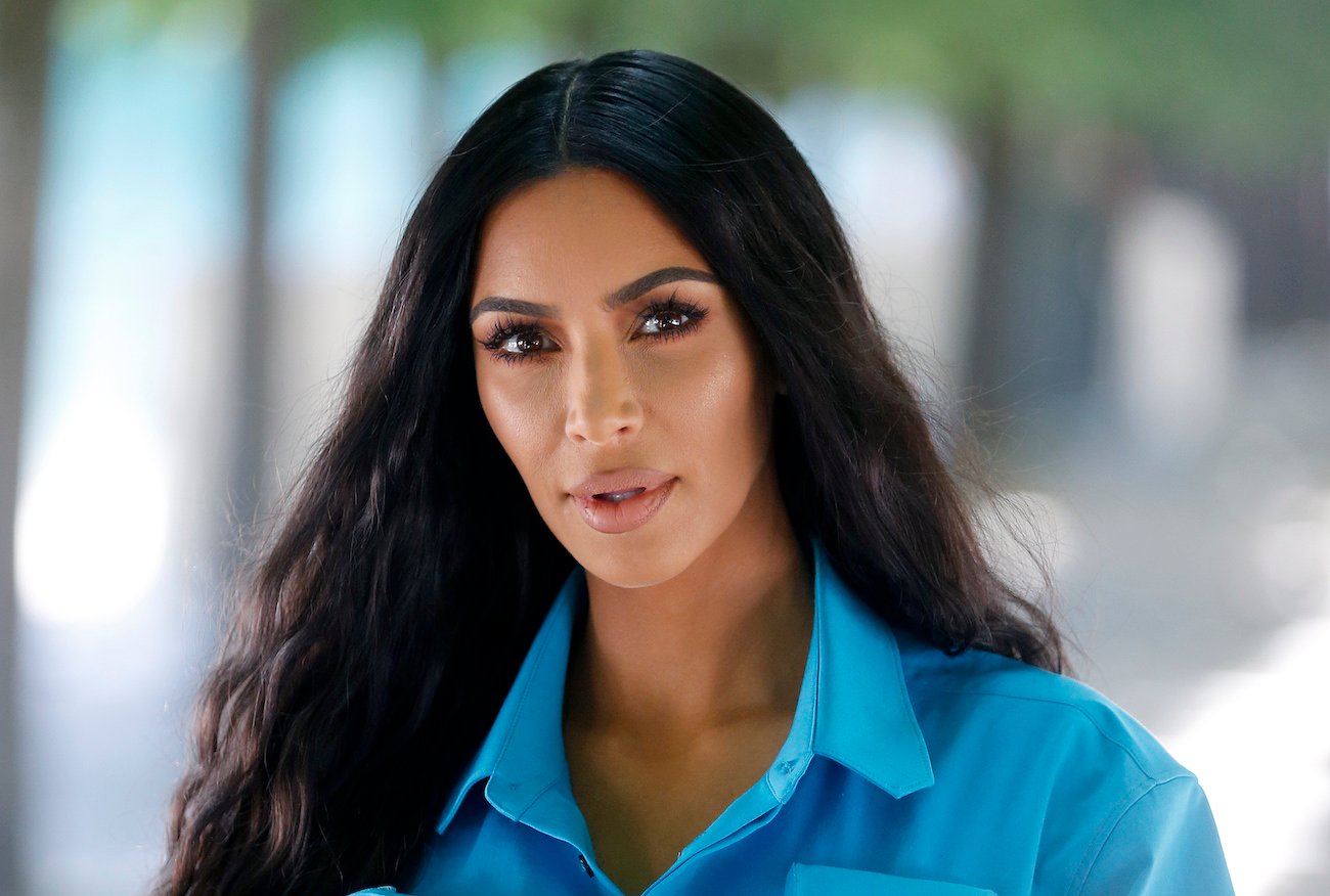 Kim Kardashian wearing a blue outfit while looking into the camera