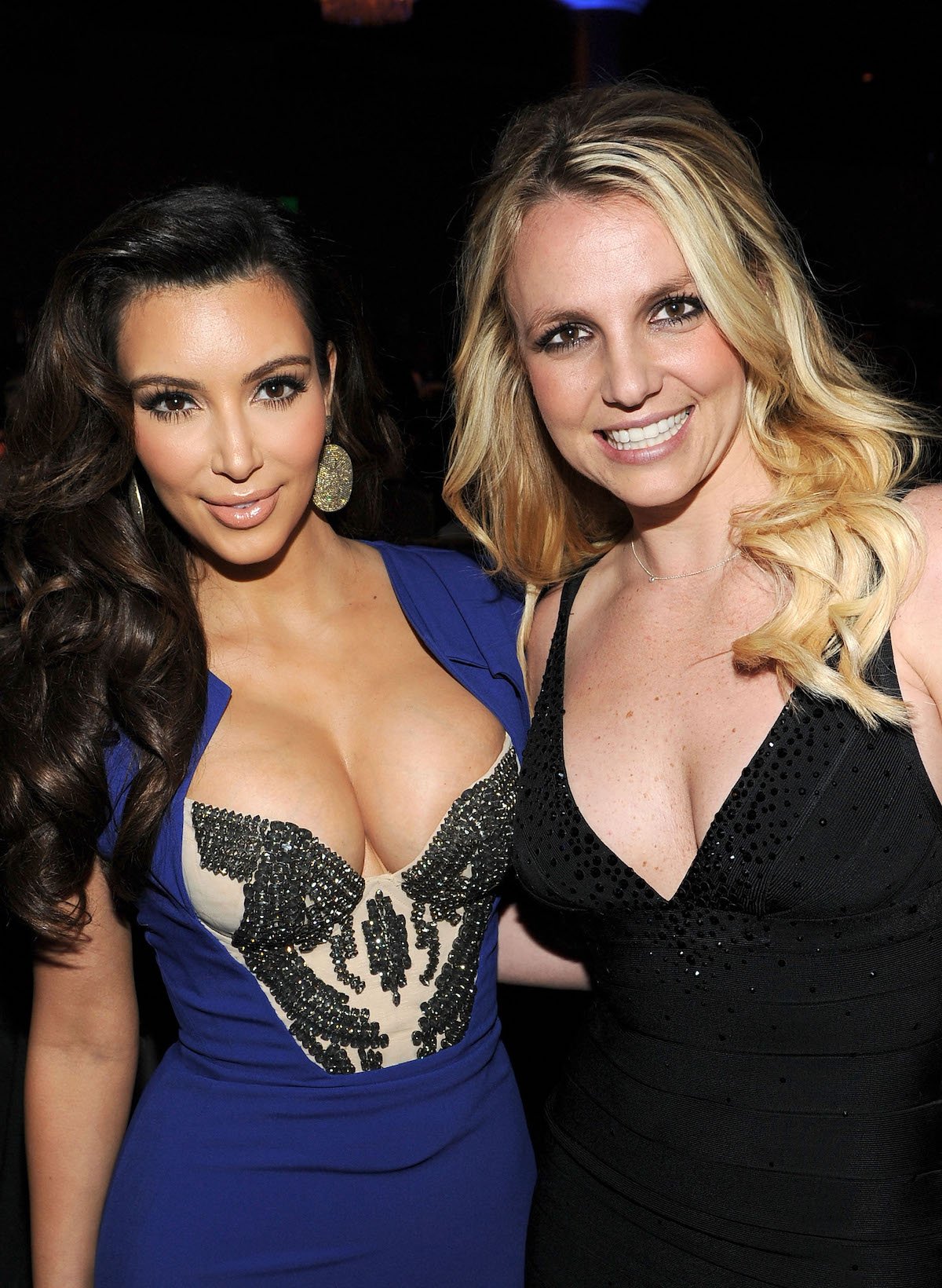 Kim Kardashian and Britney Spears pose together at an event.