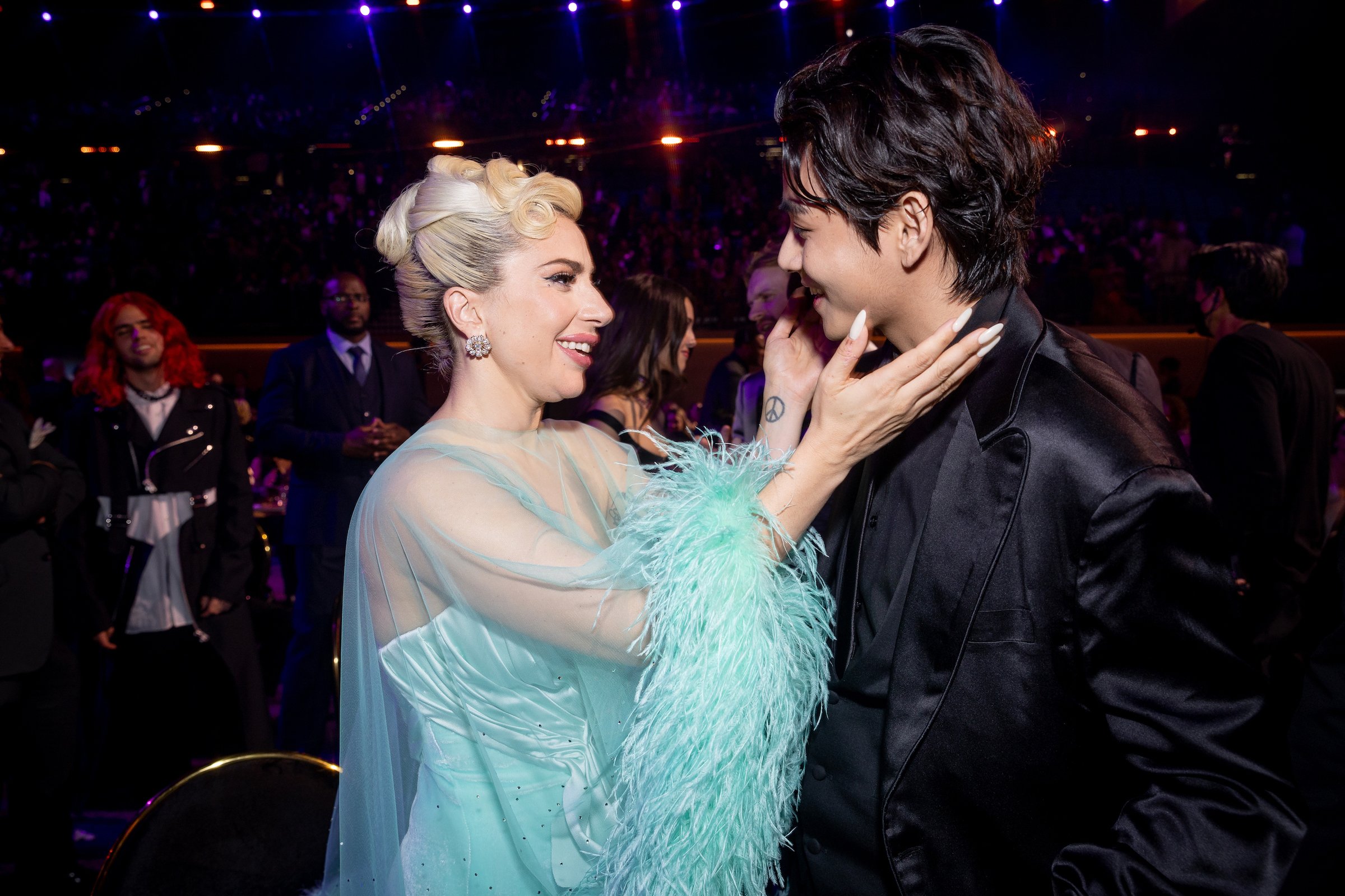 Lady Gaga and V of BTS greeting each other at the Grammys