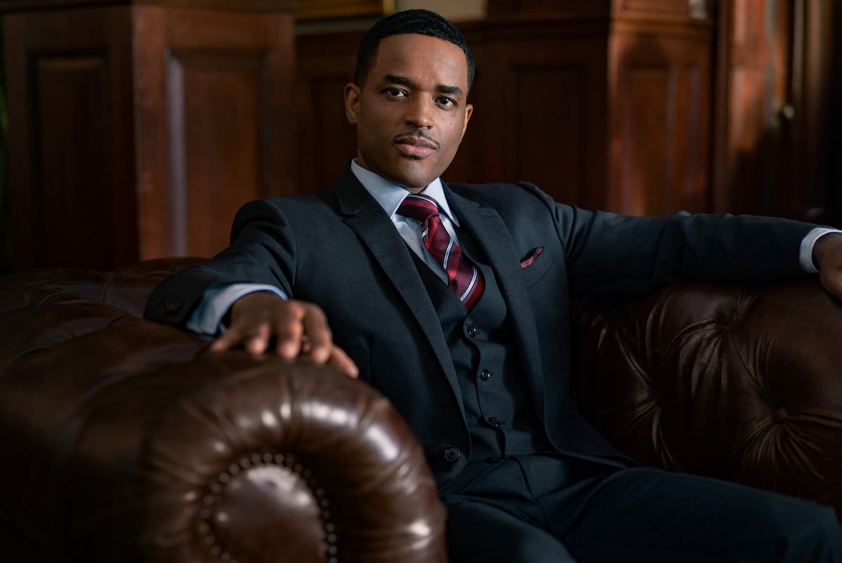 Larenz Tate as Rashad Tate wearing three piece suit and sitting in a brown leather chair in 'Power Book II: Ghost' 