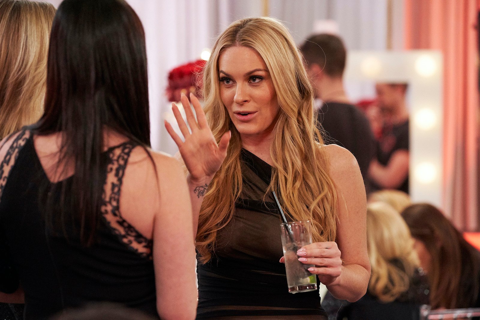 Leah McSweeney from 'RHONY' holds up her hand when talking to someone at a party