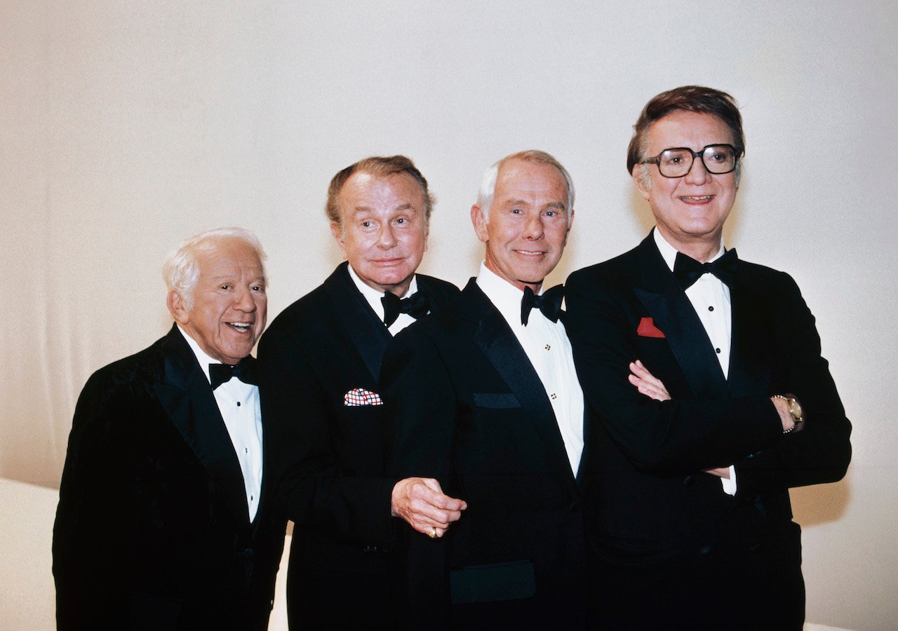 Jerry Lester, Jack Paar, Johnny Carson, and Steve Allen stand together in tuxedos for a picture. 