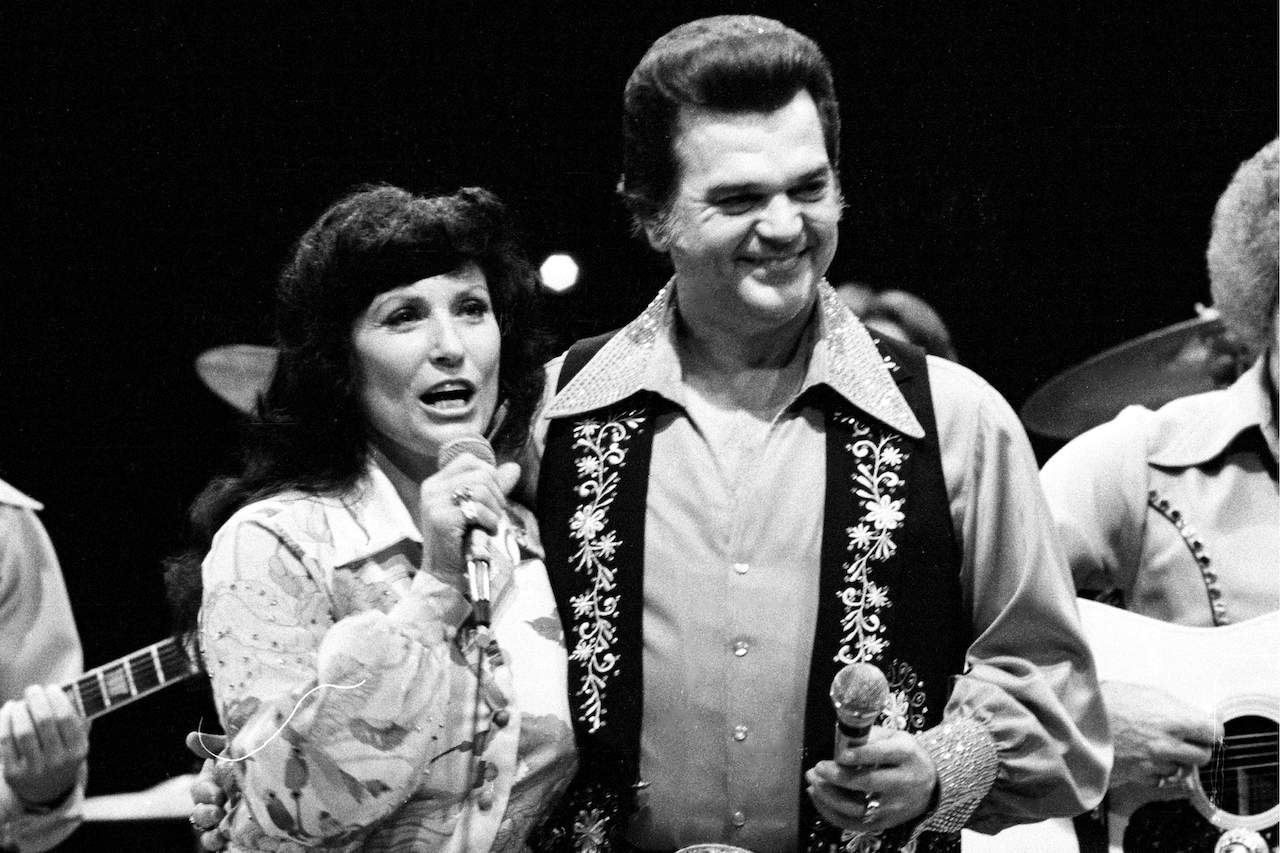Loretta Lynn and Conway Twitty performing on stage