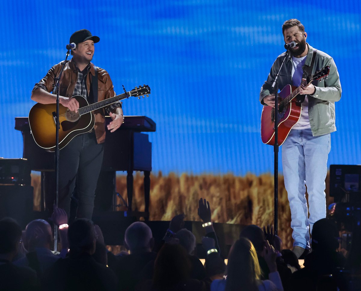 Luke Bryan and Jordan Davis performing on stage