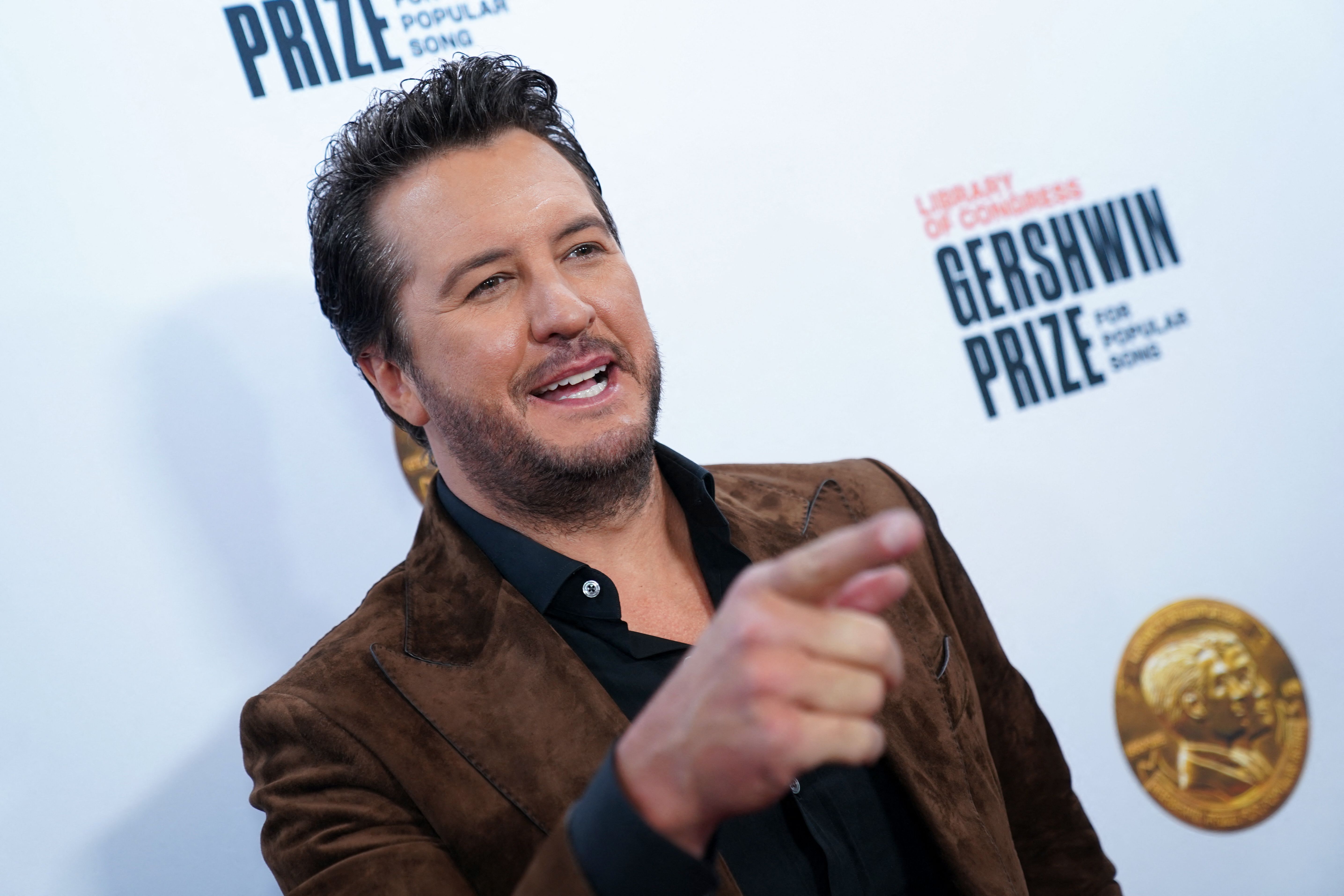 Luke Bryan, who owns a Nashville farm and Florida vacation home, arrives on the carpet at the Library of Congress Gershwin Prize Tribute Concert
