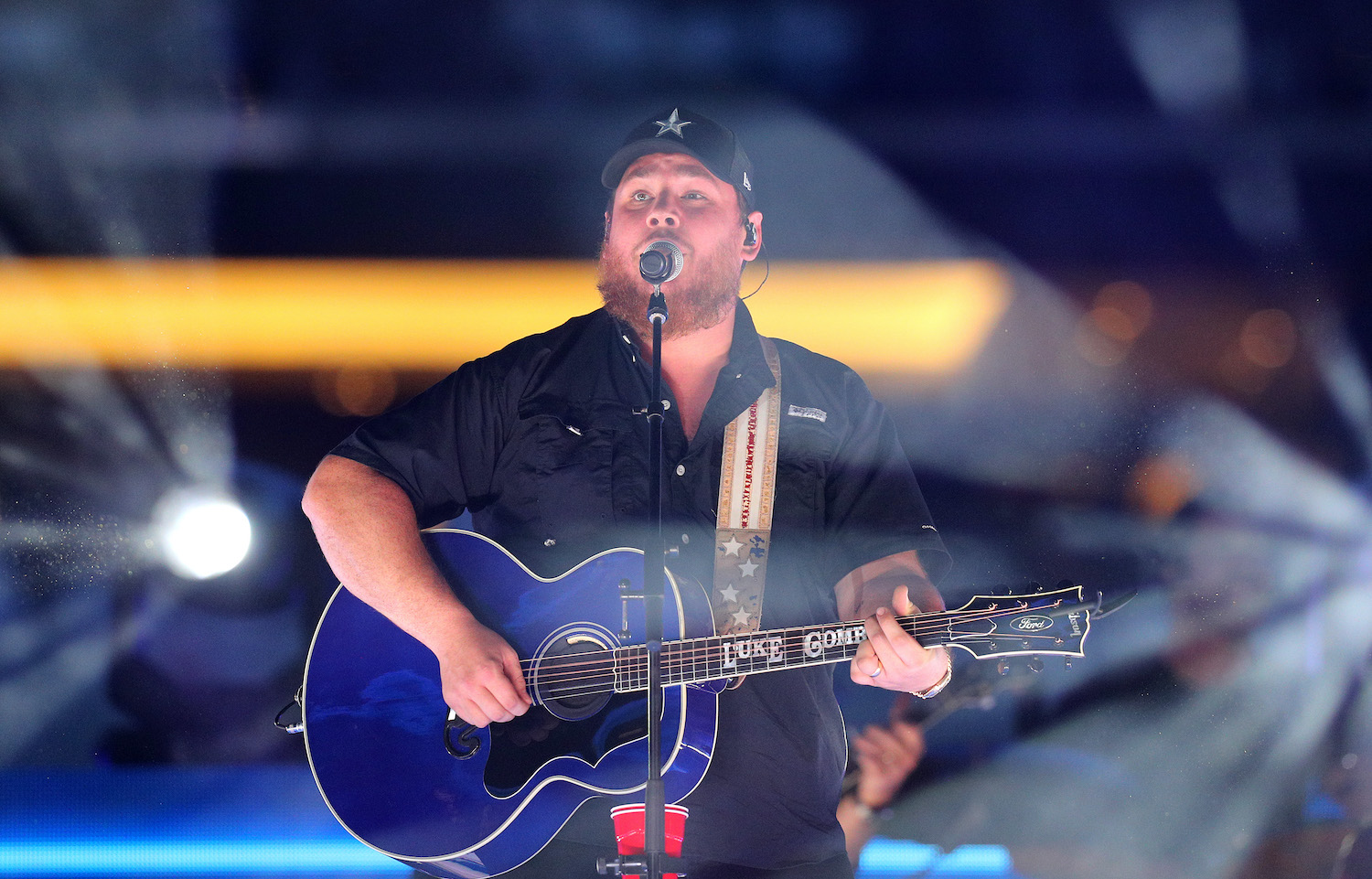 Luke Combs, whose new album drops this summer, performing live with his guitar in 2021