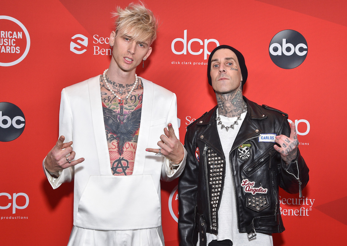 Machine Gun Kelly and Travis Barker in front of a red background