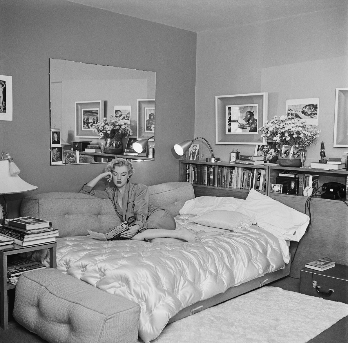 Marilyn Monroe seen reading on a sofa bed circa 1951