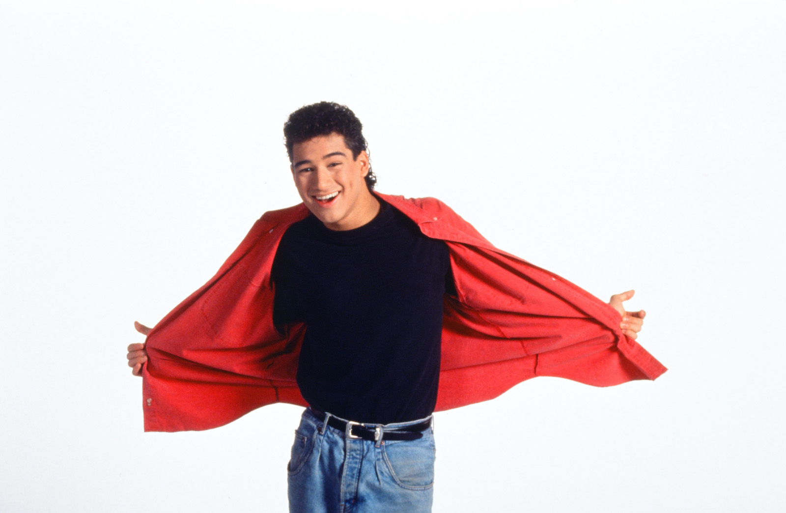 Mario Lopez from 'Saved by the Bell' smiles and holds his shirt open