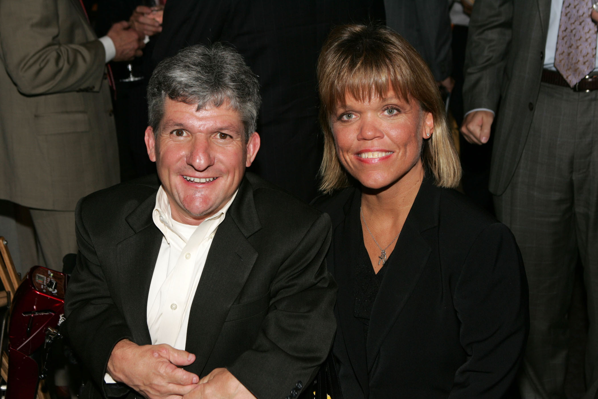 Matt and Amy Roloff from 'Little People, Big World' sitting together against a dark background and smiling