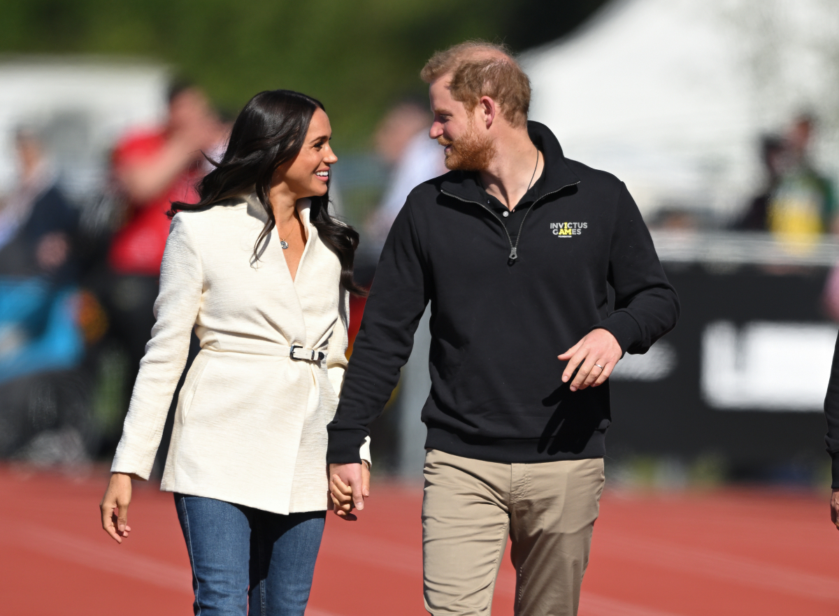 Prince Harry and Meghan Markle look in love as they attend the athletics event during the Invictus Games at Zuiderpark on April 17, 2022 in The Hague, Netherlands