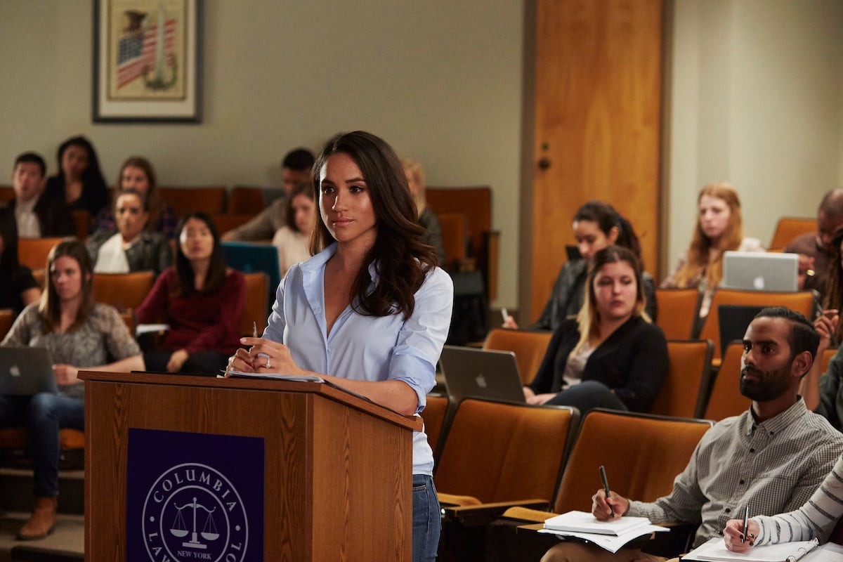 Meghan Markle, whose Oprah interview aired in 2021, stands at a podium in a scene from 'Suits'