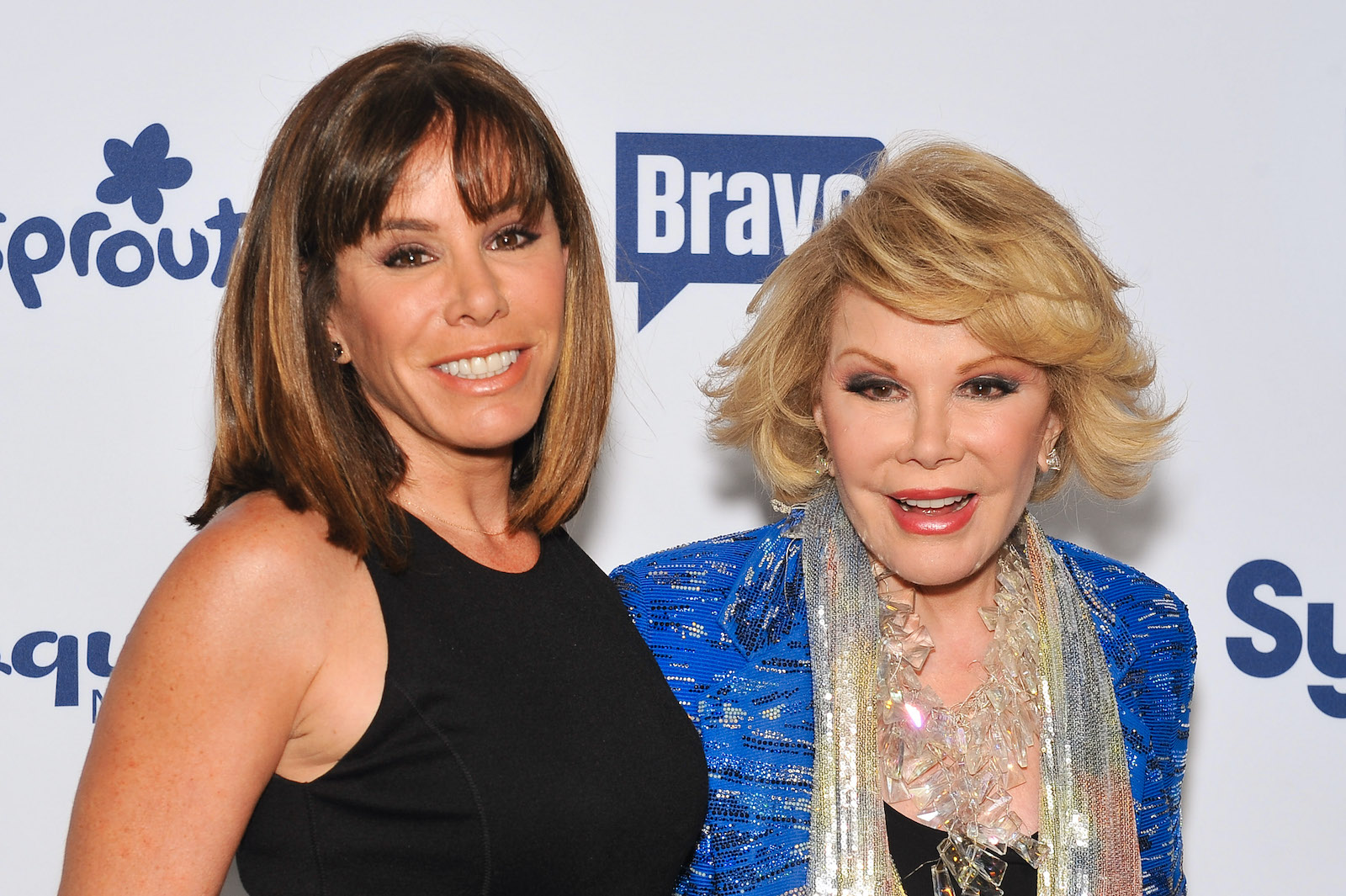 Joan Rivers and Melissa Rivers smile on the step and repeat at an event in 2014