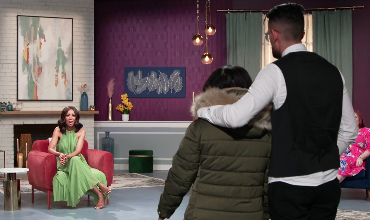 Memphis and Hamza Moknii standing in the foreground on the set of '90 Day Fiancé: Before the 90 Days' Season 5 tell-all, in front of the host, Shaun Robinson.