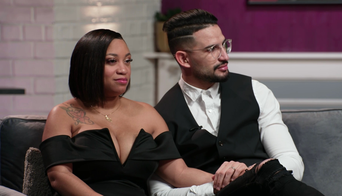 Memphis Smith wearing a black dress, sitting beside Hamza who is wearing a suit during the '90 Day Fiancé: Before the 90 Days' Season 5 tell-all.