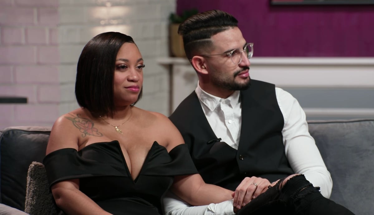 Memphis Smith wears a black dress and is seated next to Hamza who is wearing a suit during Season 5 of '90 Day Fiancé: Before the 90 Days'.