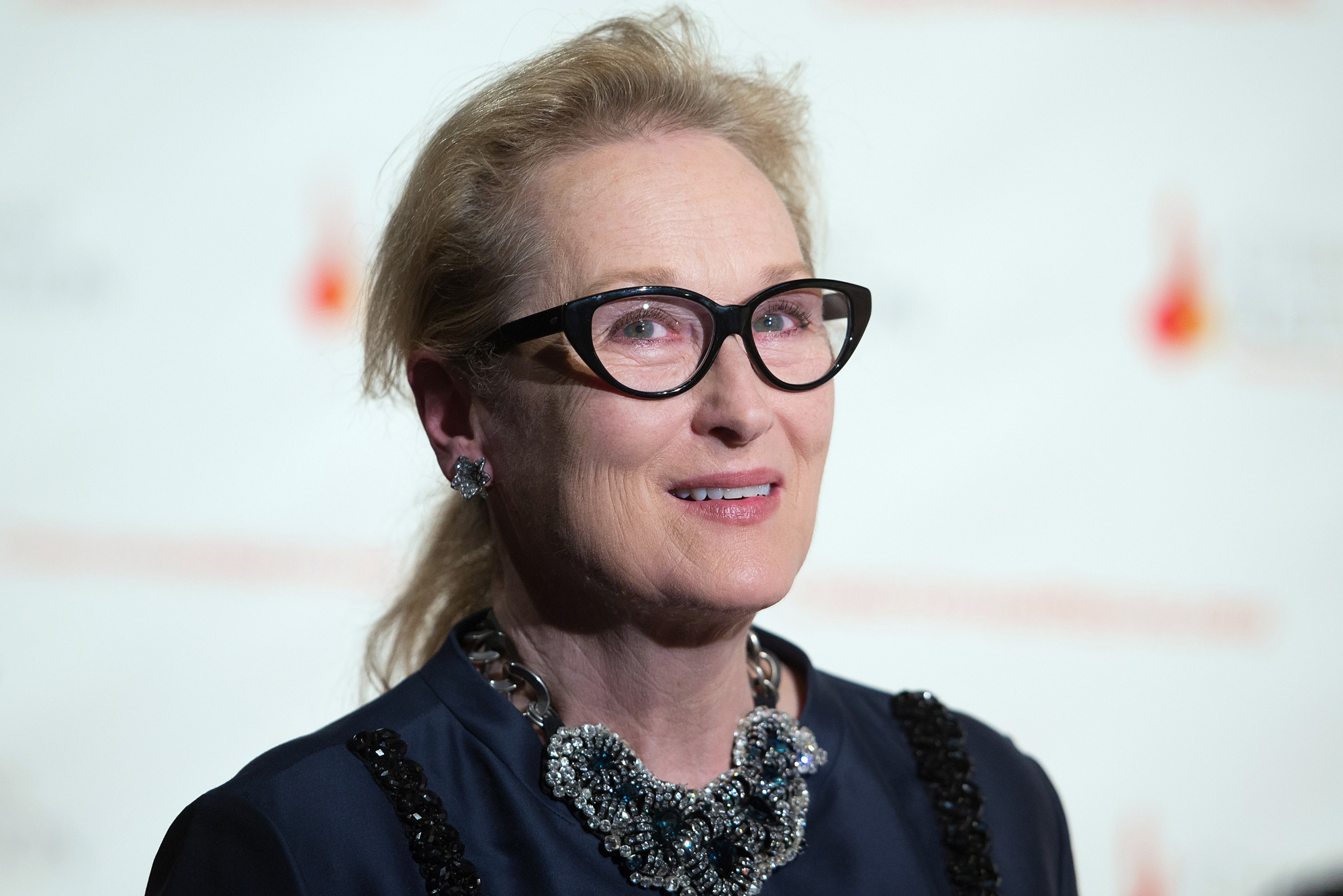 Meryl Streep at a gala performance in front of a white step and repeat