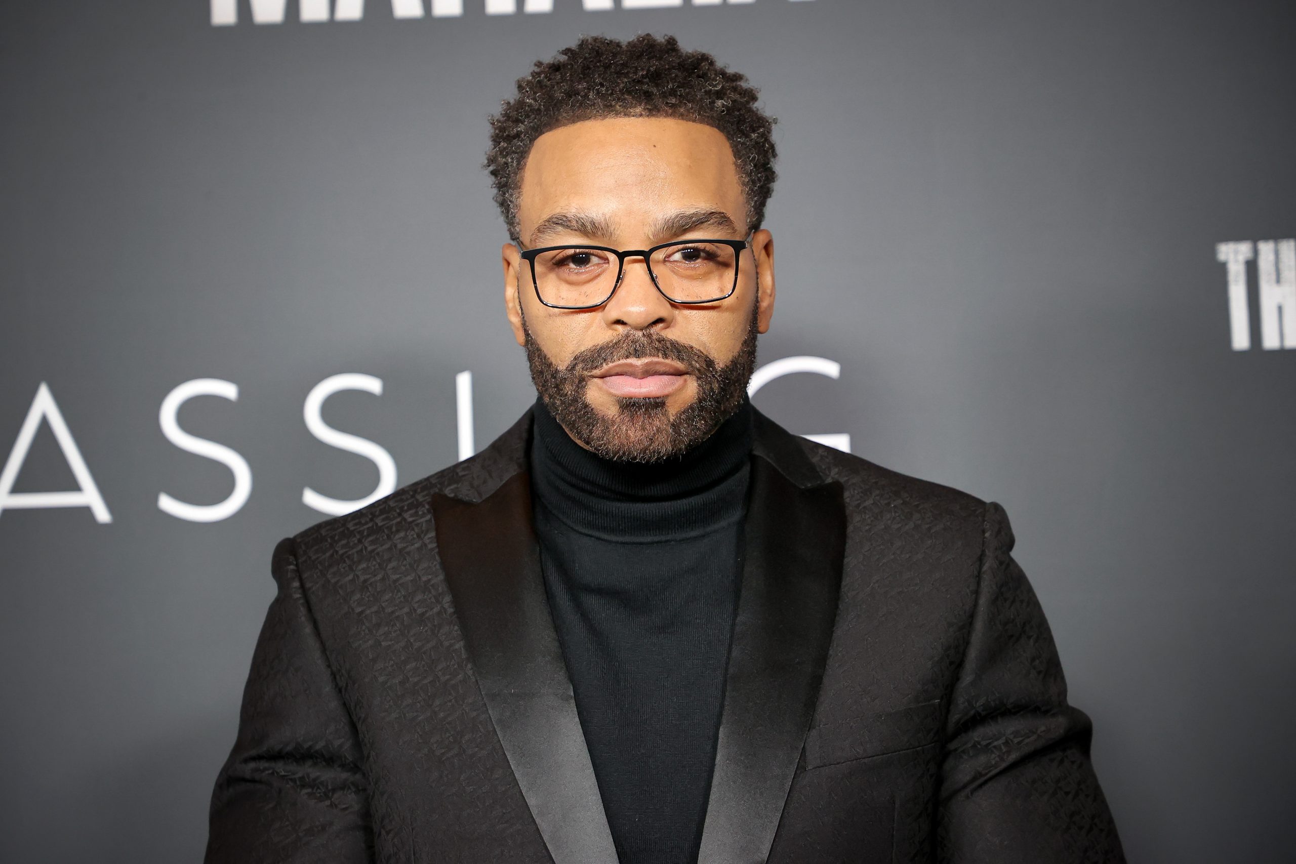 Method Man wearing glasses on a black background