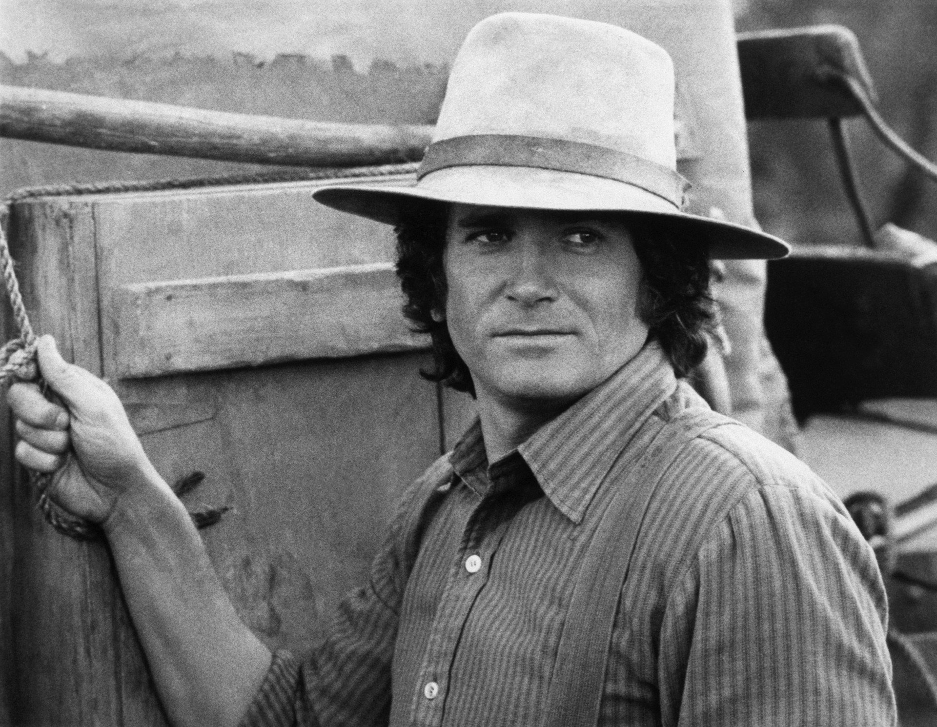 Michael Landon wears a cowboy hat on the set of Little House on the Prairie.