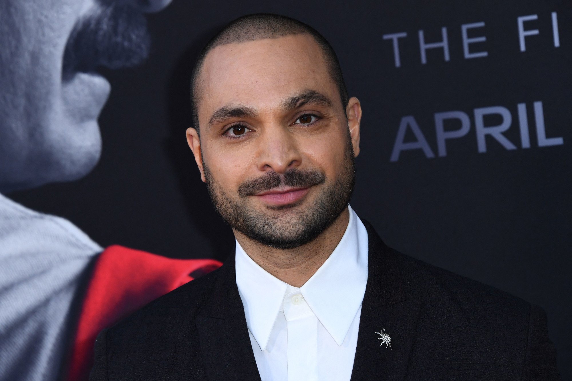 Michael Mando joins the 'Better Call Saul' cast at the premiere for season 6. He's wearing a white collared shirt and black jacket.