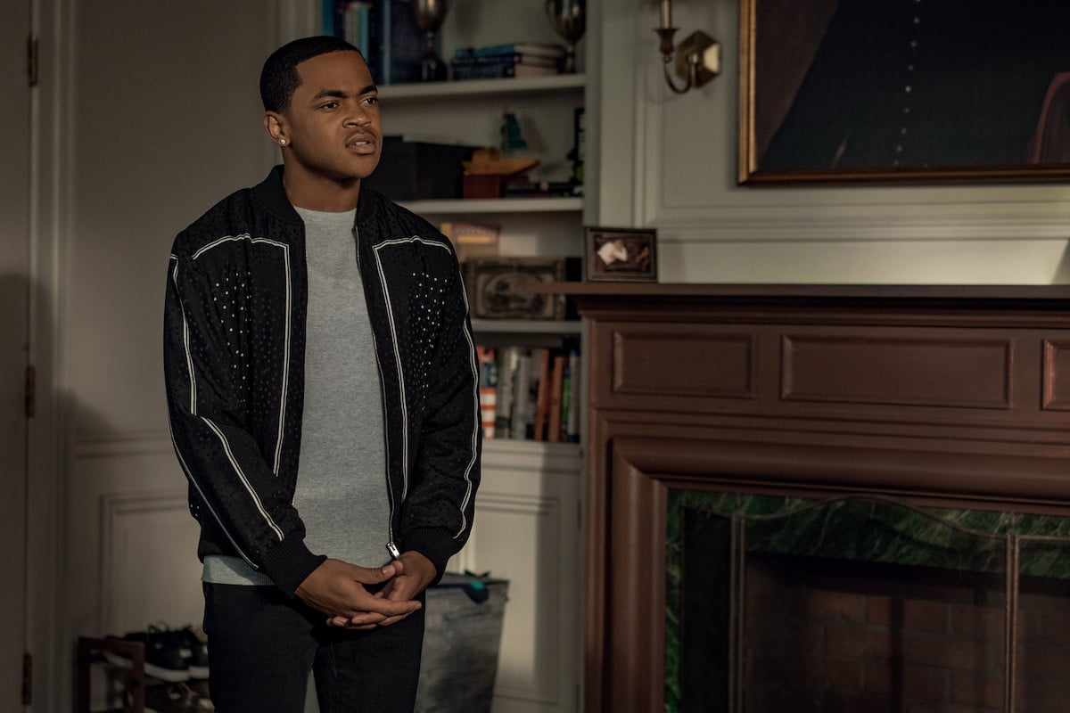 Michael Rainey Jr. as Tariq St. Patrick wearing a grey shirt and black jacket in 'Power Book II: Ghost'