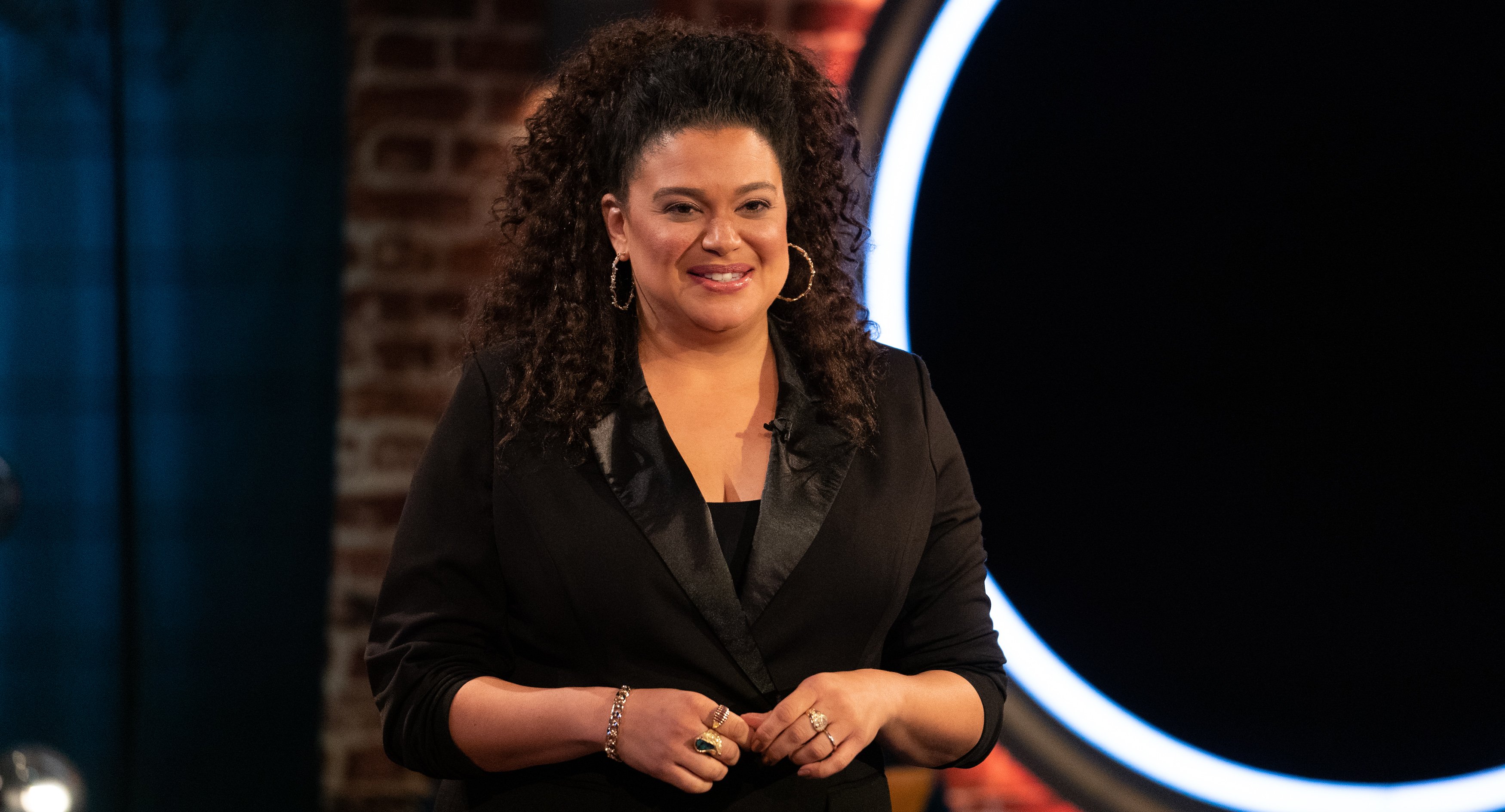 Michelle Buteau standing and smiling during 'The Circle' Season 3 finale