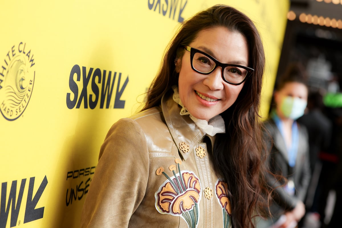Michelle Yeoh wears glasses and smiles on red carpet