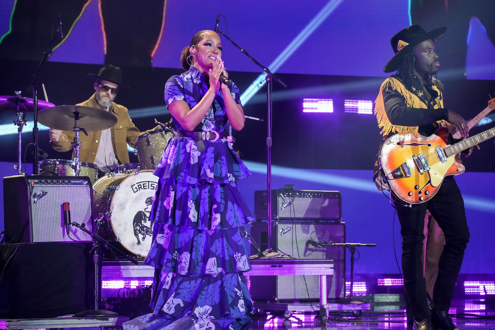 Mickey Guyton smiles while performing with Eric Burton of Black Pumas at the 2022 CMT Music Awards